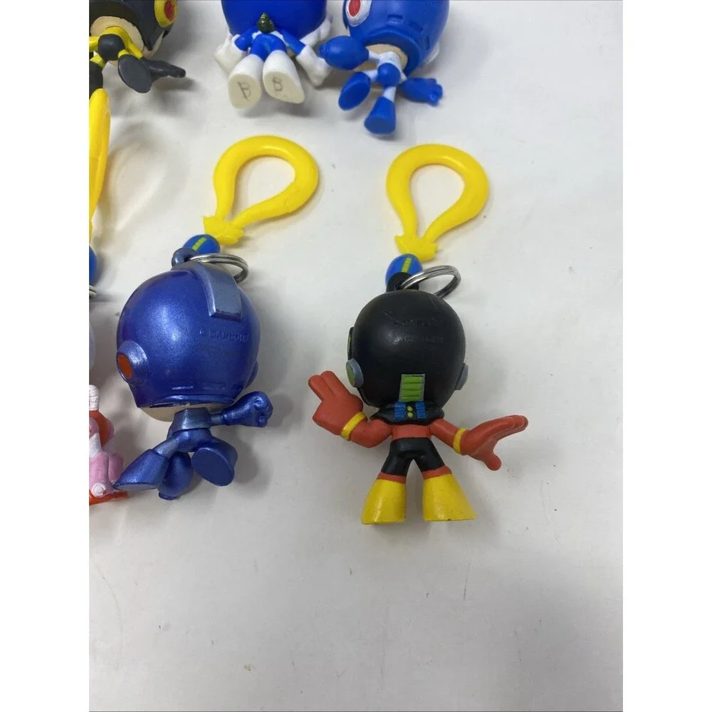 lot of 9 CAPCOM MEGA MAN BACKPACK HANGERS METALLIC FIRE MAN JUST TOYS INTL.